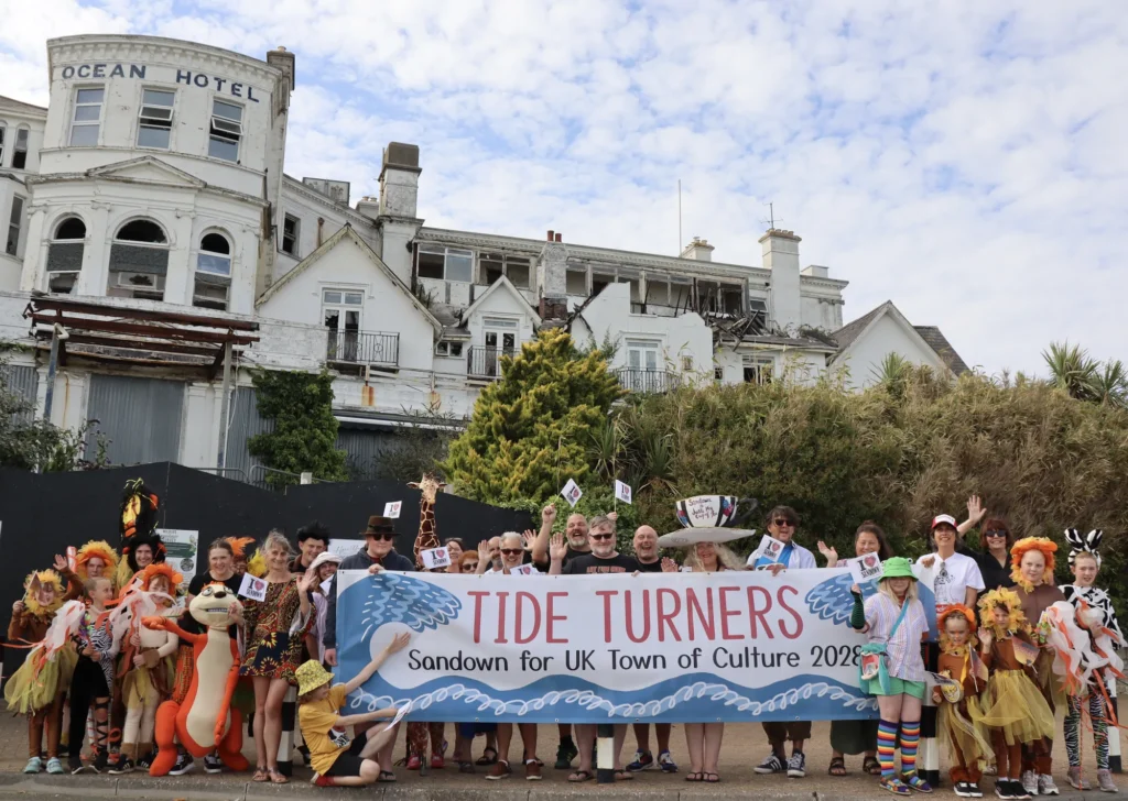 Tide Turners supporters holding a Sandown for UK Town of Culture 2028 banner